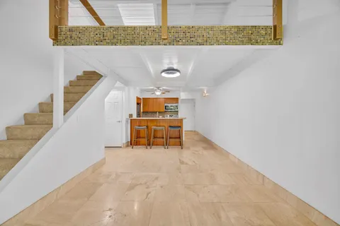 a room with stairs and a rug