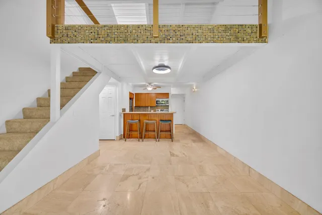 a room with stairs and a rug