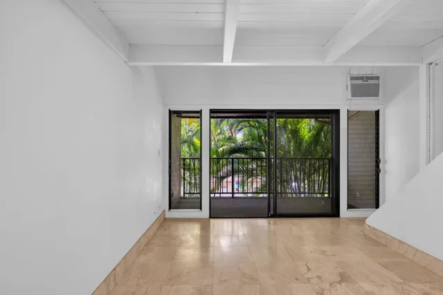 a view of an empty room with a balcony