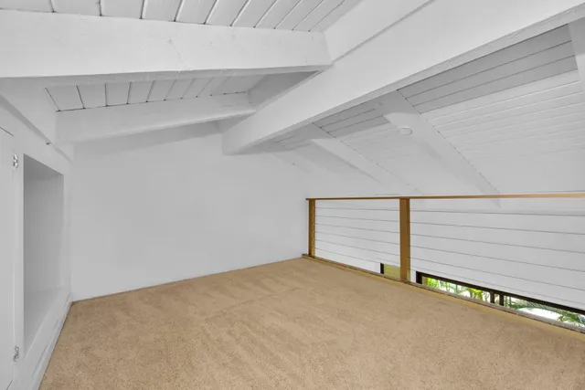 a bedroom with a bed and cabinets