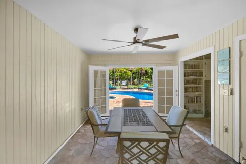 a backyard of a house with a yard and outdoor seating
