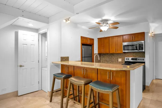 a kitchen with stainless steel appliances a stove a refrigerator and microwave