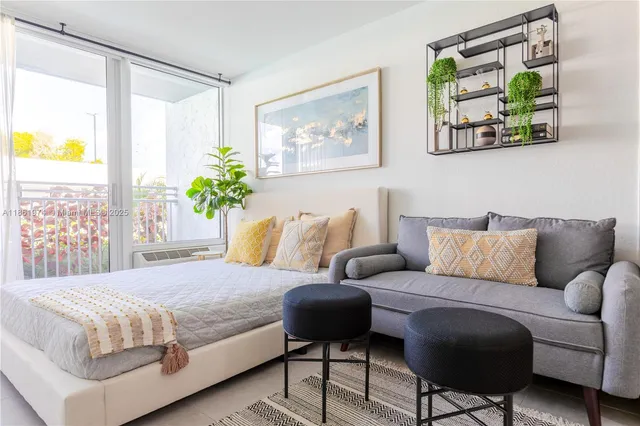a bedroom with a bed couch and painting on the wall
