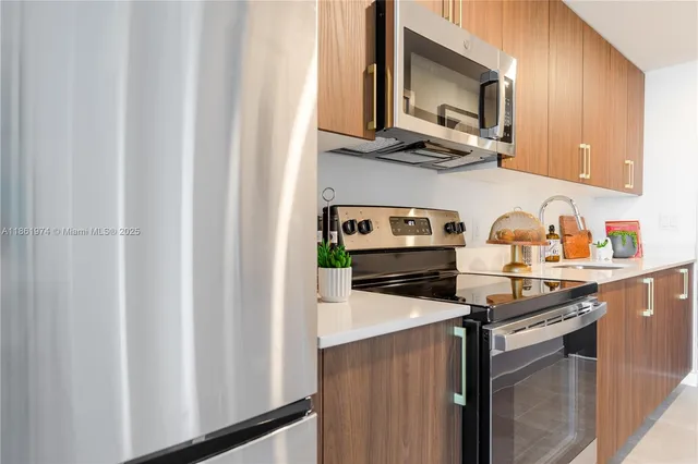 a kitchen with stainless steel appliances a stove a microwave and cabinets