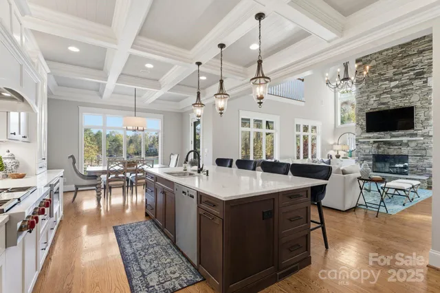 a large white kitchen with a large island in the center