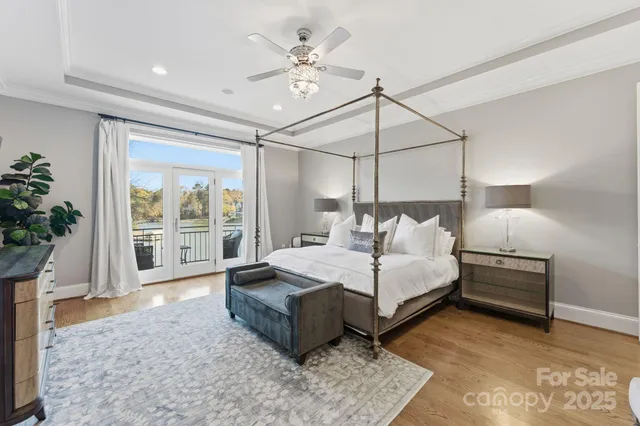 a bed room with a bed window and a chandelier