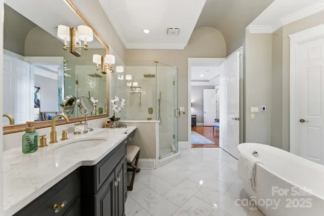 a spacious bathroom with a shower a sink and a mirror