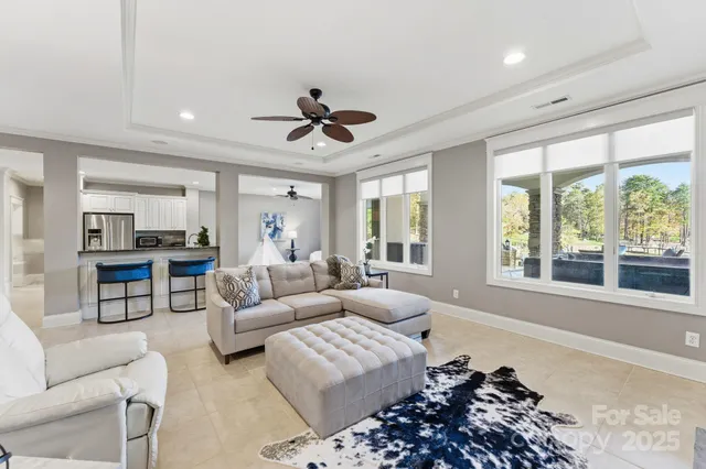 a living room with furniture a piano and a potted plant