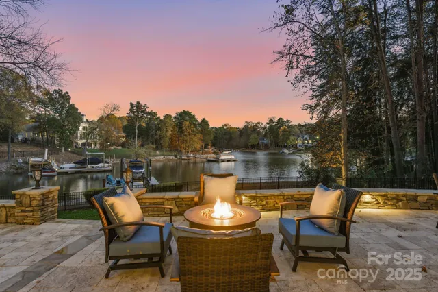 a view of a lake with table and chairs