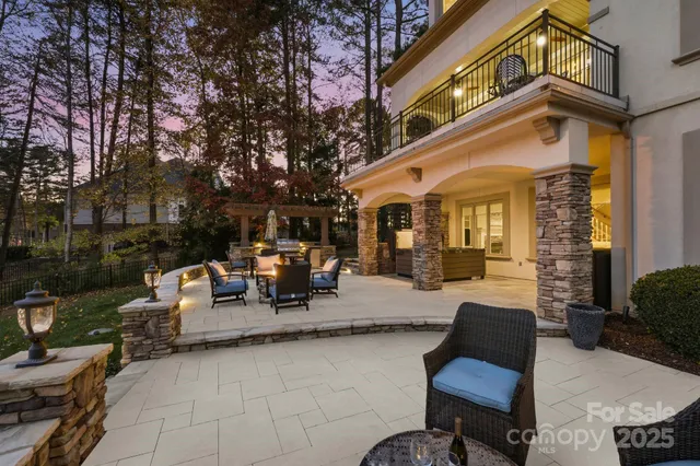 a view of a patio with couches table and chairs and potted plants