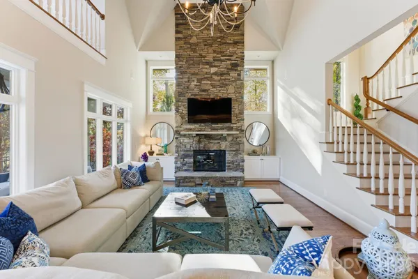 a bed room with a bed window and a chandelier