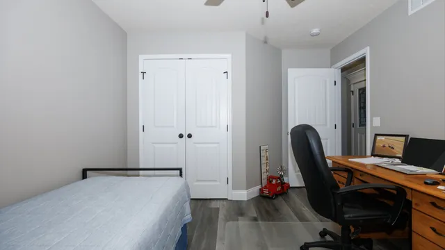 a view of a workspace with wooden floor and furniture