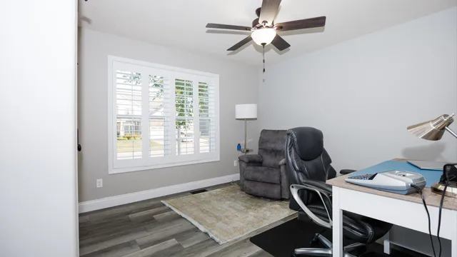 a large bed sitting in a bedroom next to a window