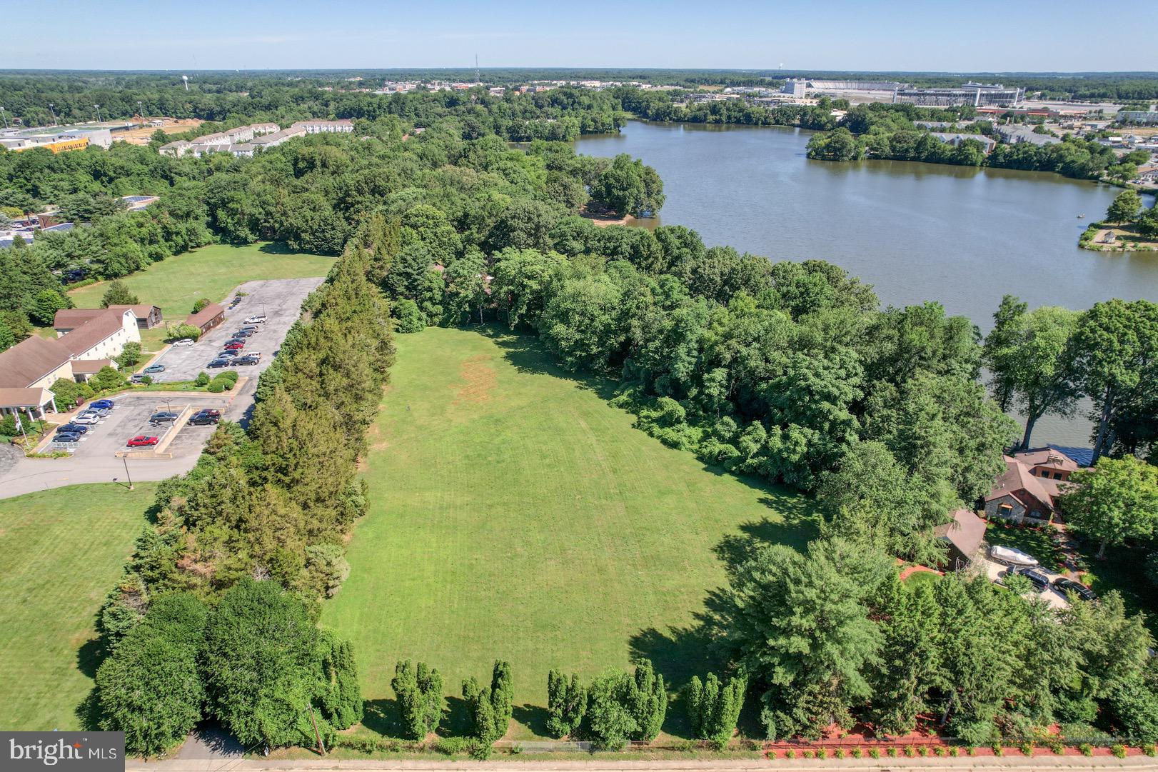 an aerial view of lake and residential houses with outdoor space