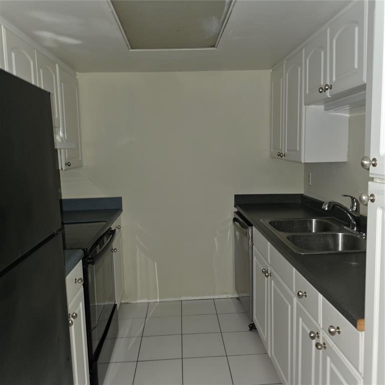 922 Lake Destiny Road, Unit F Altamonte Springs, FL 32714 - Photo 5 of 17 a kitchen with a sink stove and refrigerator