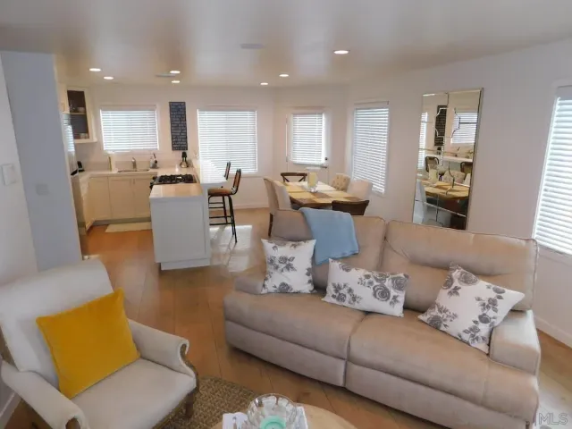 a living room with furniture kitchen and a table