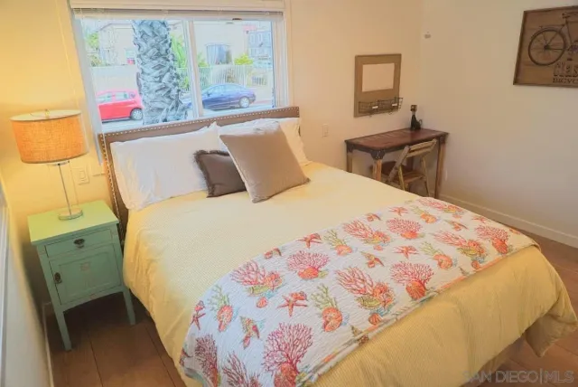 a large bed sitting in a bedroom next to a window