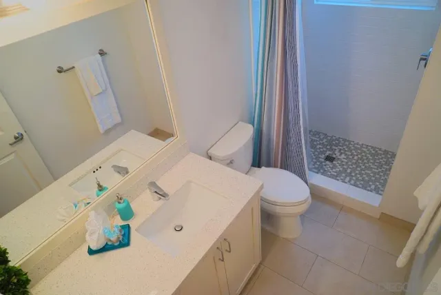 a white toilet sitting next to a bath tub