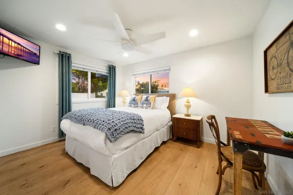 a bedroom with a large bed and a chandelier