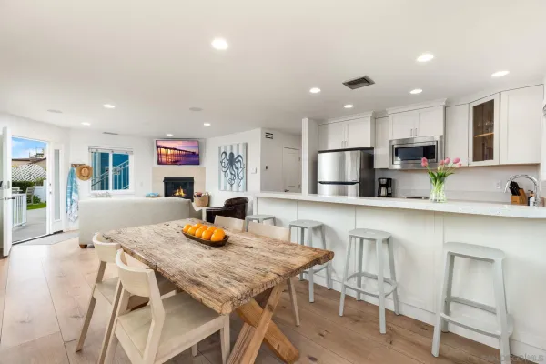 a kitchen with kitchen island granite countertop a counter space cabinets stainless steel appliances and a refrigerator