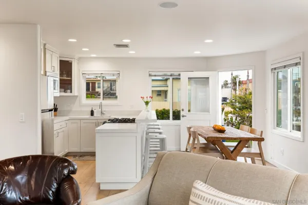 a kitchen with stainless steel appliances a microwave a sink and a refrigerator