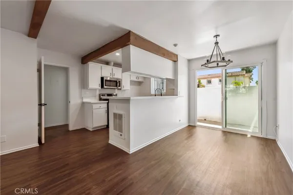 a view of a livingroom with kitchen and furniture