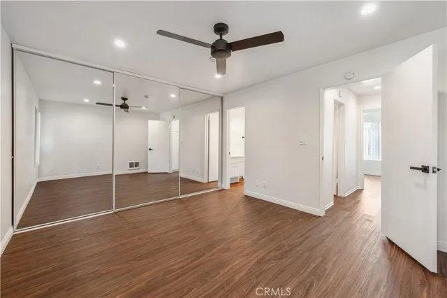 a view of empty room with wooden floor and fireplace