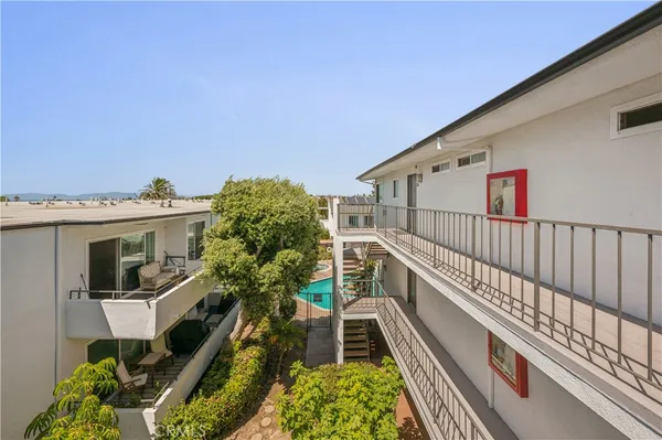 a view of balcony with wooden floor and fence