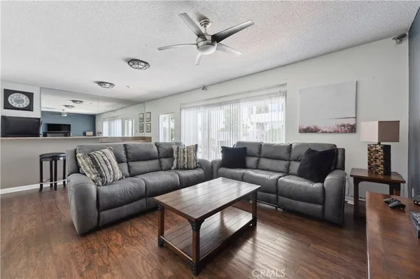 a living room with furniture or kitchen view and a wooden floor