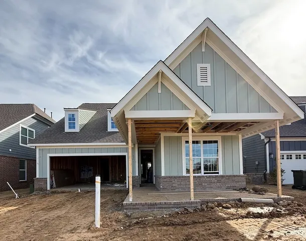 a front view of a house with yard and parking space