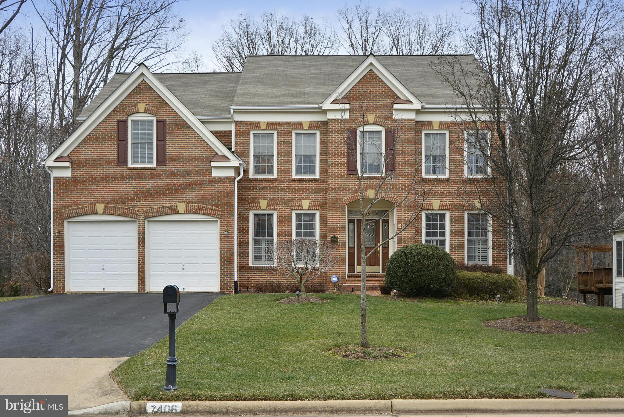 7406 Spring Summit Road Springfield, VA 22150 - Photo 1 of 30 a view of a brick house with a yard