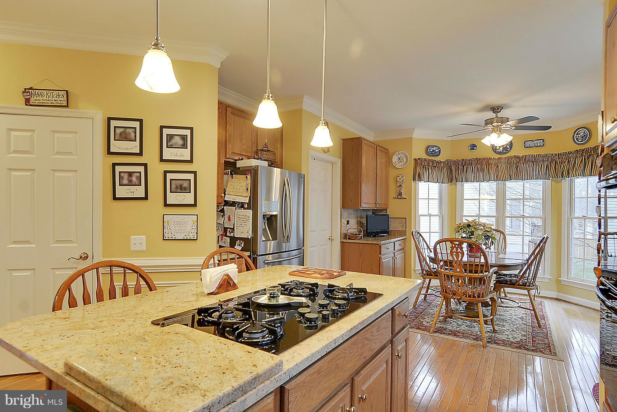 7406 Spring Summit Road Springfield, VA 22150 - Photo 11 of 30 a kitchen with a table and chairs