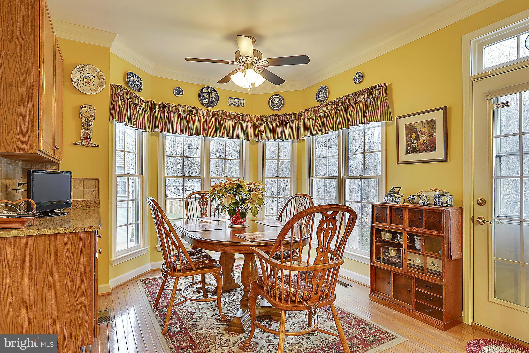 7406 Spring Summit Road Springfield, VA 22150 - Photo 12 of 30 a view of a dining room with furniture and a chandelier