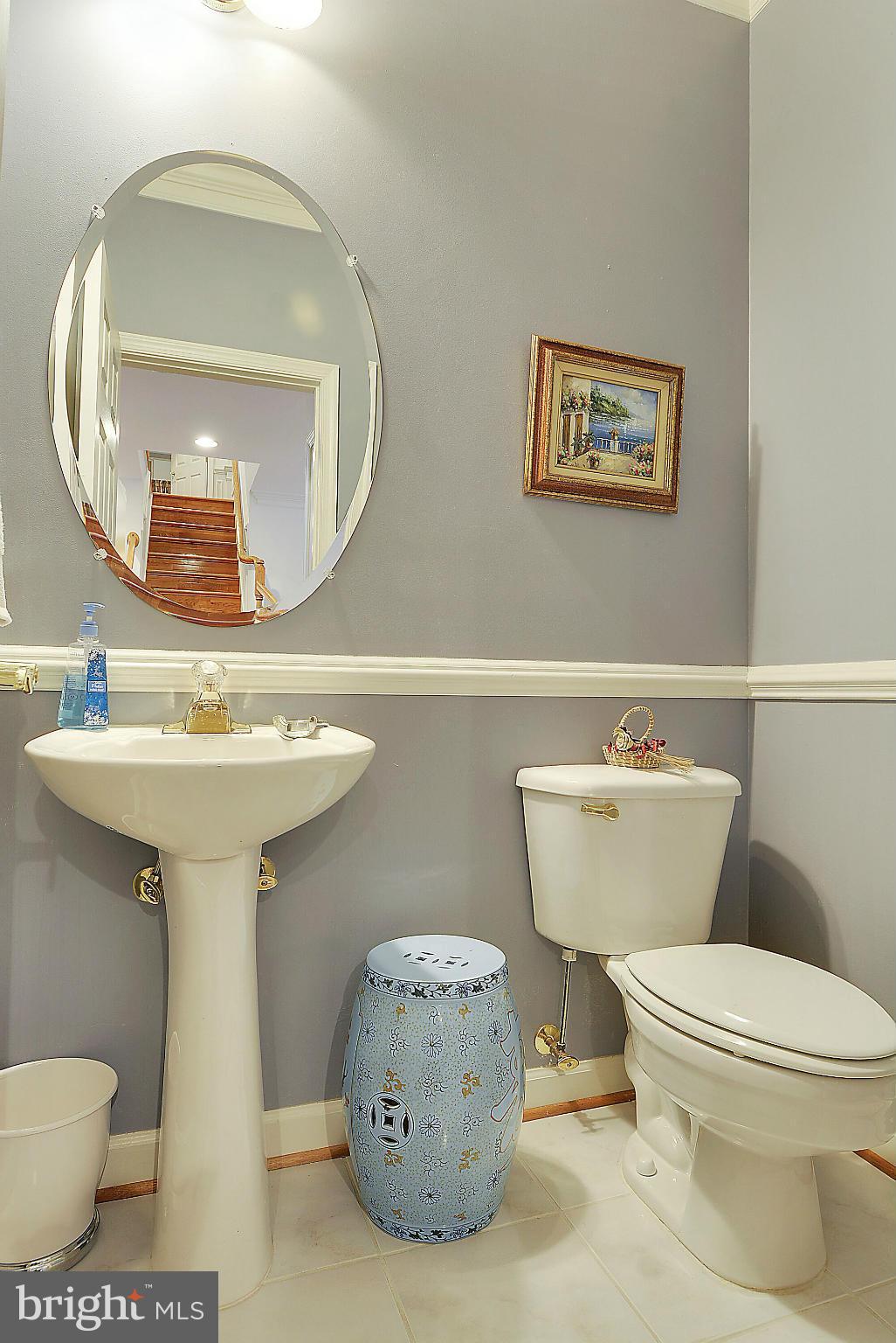 7406 Spring Summit Road Springfield, VA 22150 - Photo 14 of 30 a bathroom with a toilet sink and mirror
