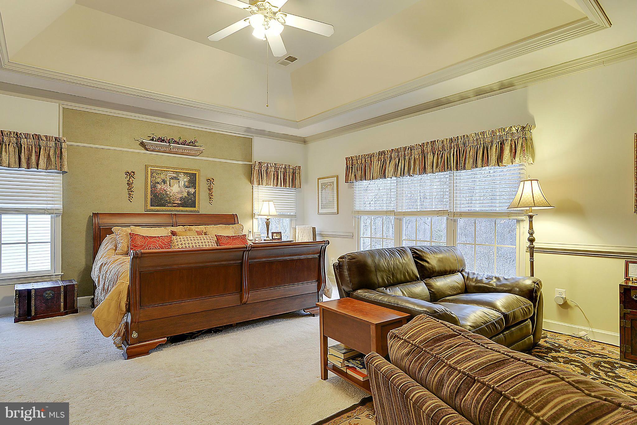 7406 Spring Summit Road Springfield, VA 22150 - Photo 15 of 30 a bedroom with a bed and a couch