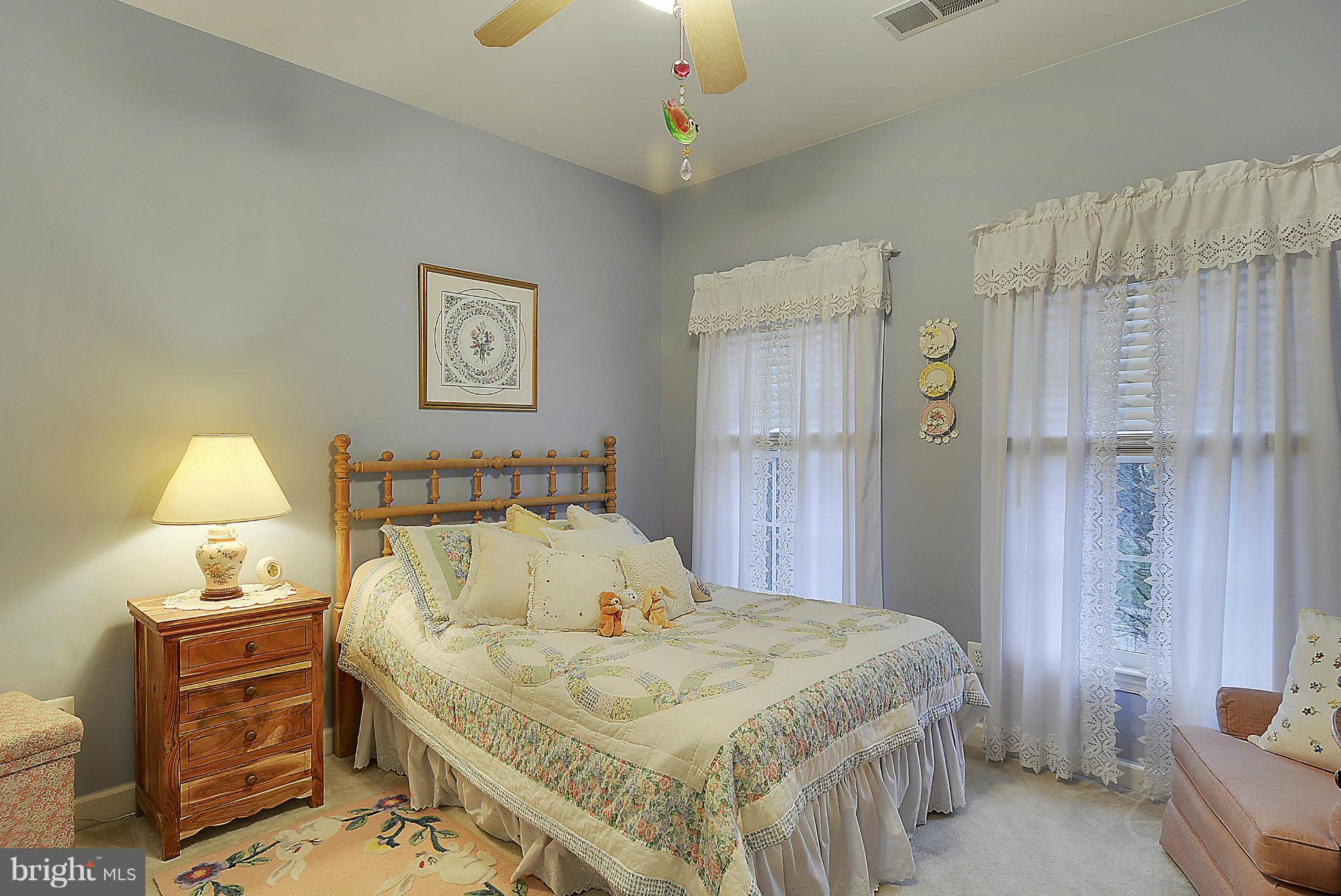 7406 Spring Summit Road Springfield, VA 22150 - Photo 19 of 30 a bed room with a bed and a lamp