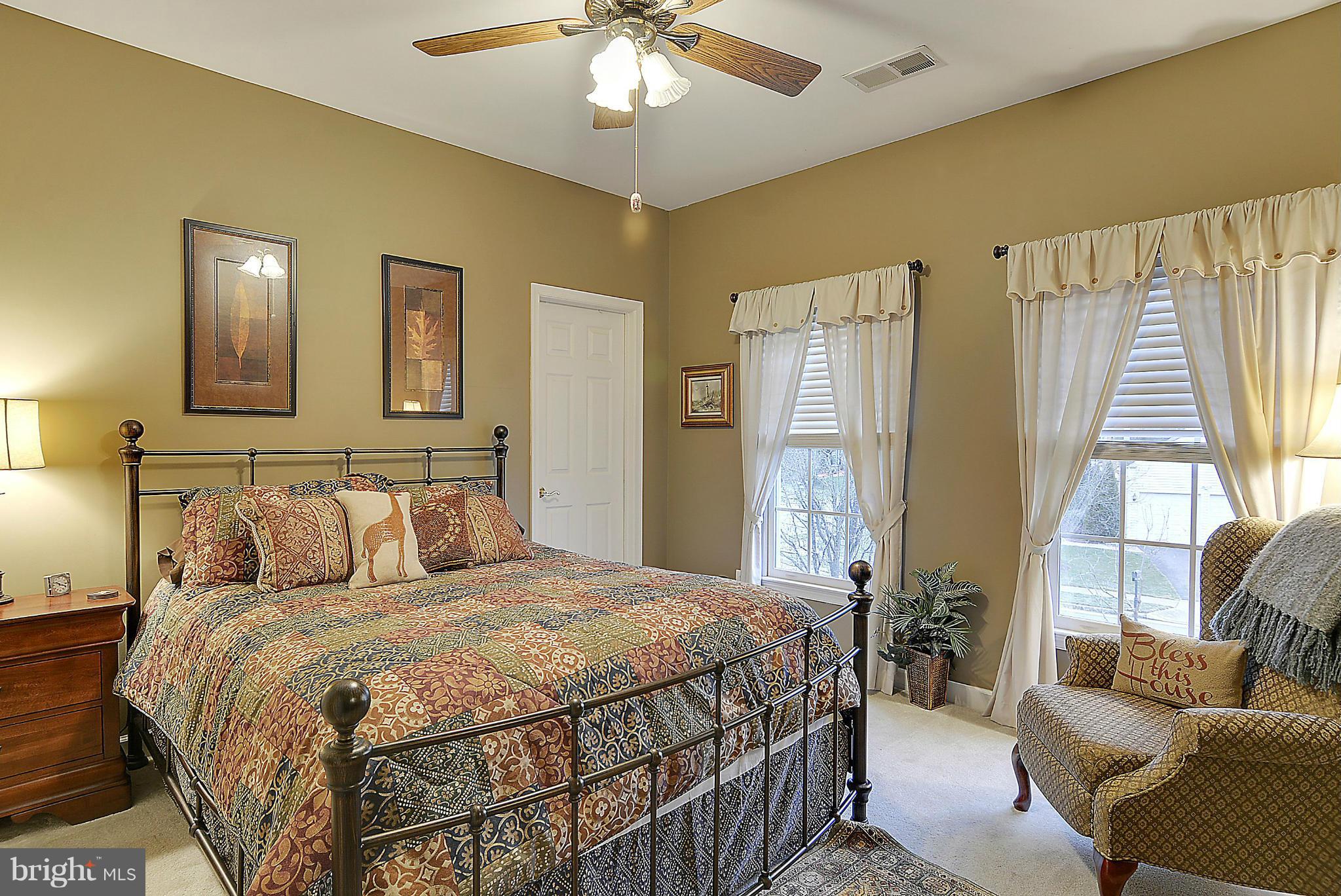 7406 Spring Summit Road Springfield, VA 22150 - Photo 20 of 30 a bedroom with a large bed couch and a window