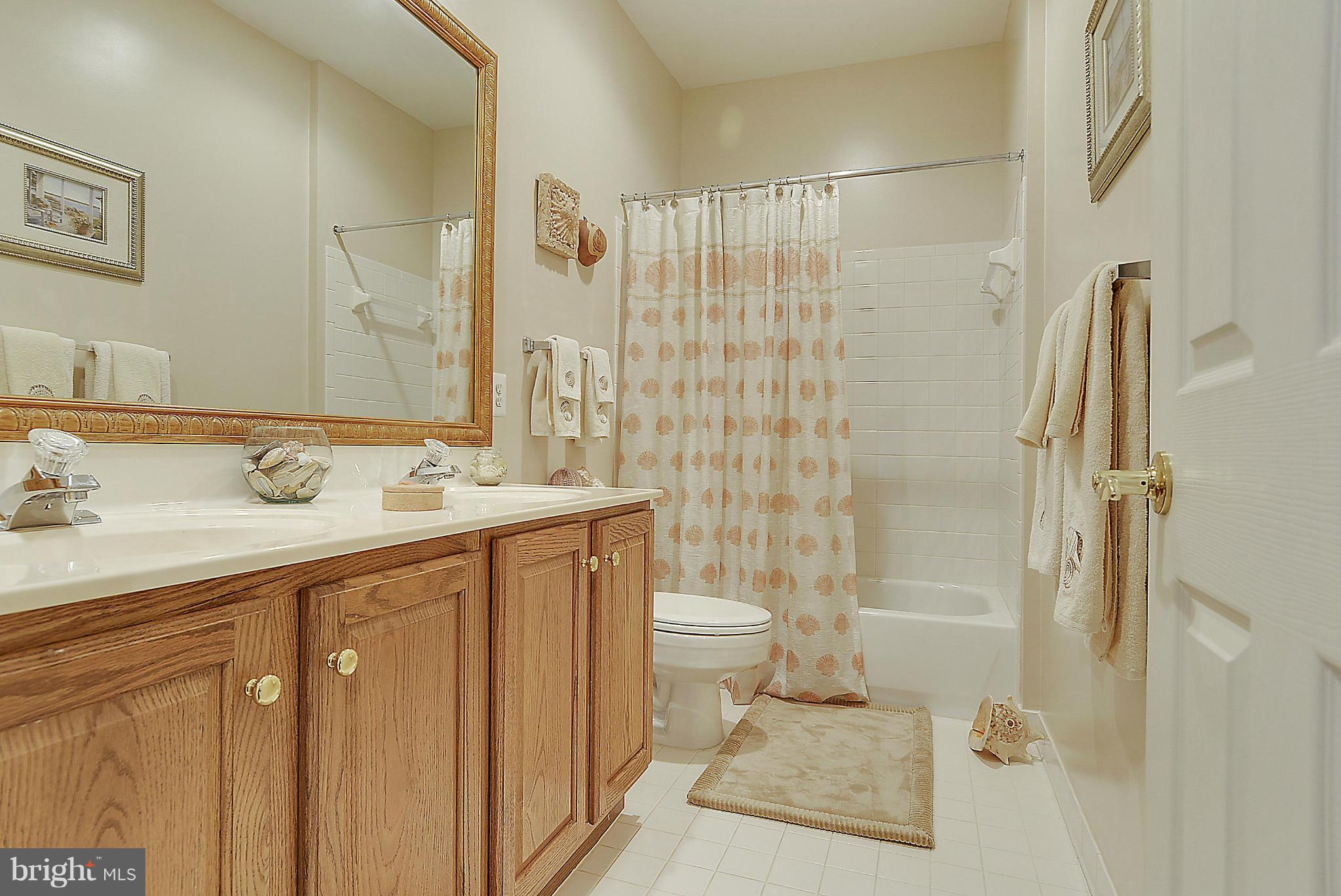 7406 Spring Summit Road Springfield, VA 22150 - Photo 22 of 30 a bathroom with a sink a toilet and shower