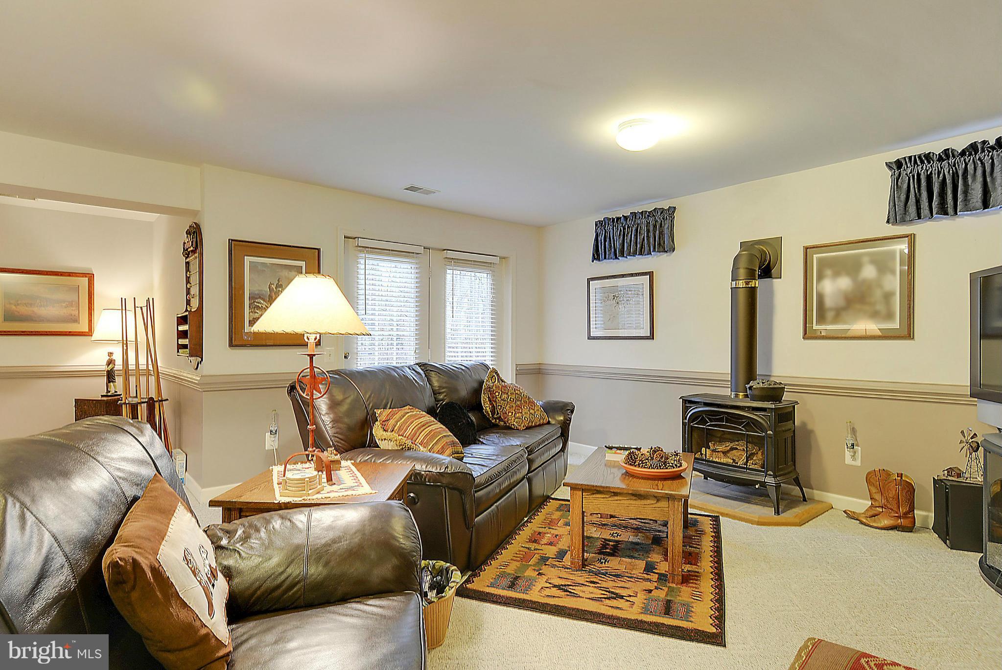 7406 Spring Summit Road Springfield, VA 22150 - Photo 25 of 30 a living room with furniture and a flat screen tv