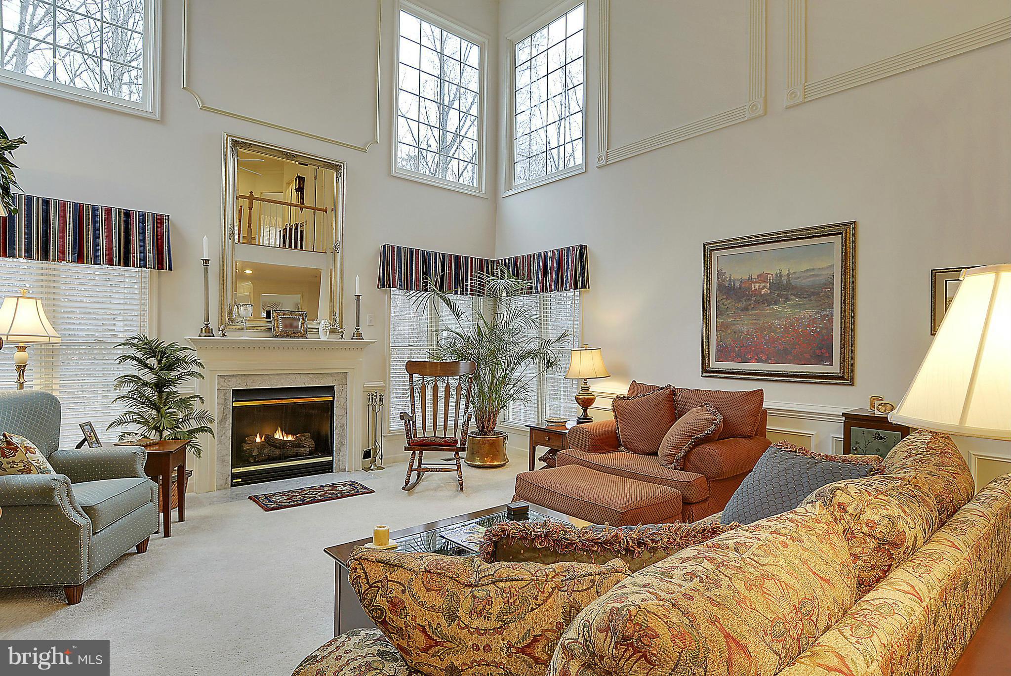 7406 Spring Summit Road Springfield, VA 22150 - Photo 8 of 30 a living room with furniture fireplace and a large window