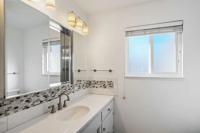a bathroom with a sink a vanity and a mirror