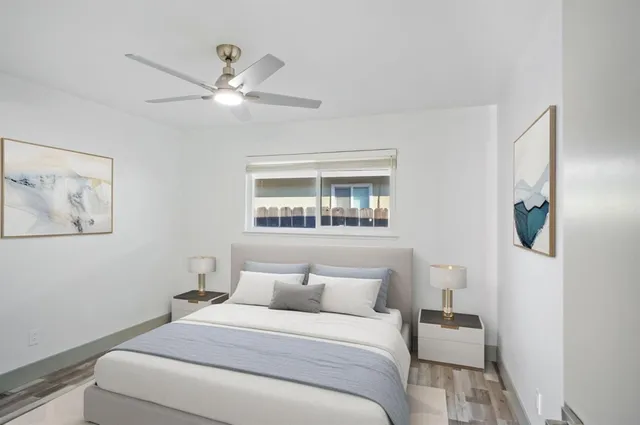 a bedroom with a large bed and a window