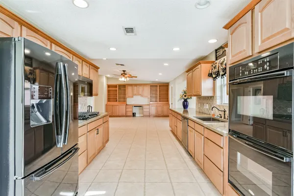 a large kitchen with stainless steel appliances lots of counter top space