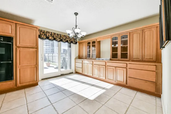 a kitchen with stainless steel appliances kitchen island granite countertop a refrigerator and cabinets