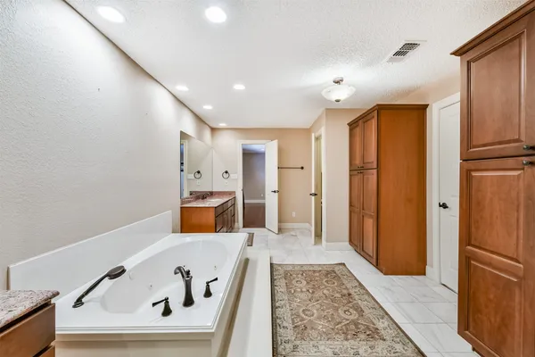 a view of a kitchen with a sink and refrigerator