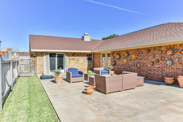 a view of a patio with couches and potted plants