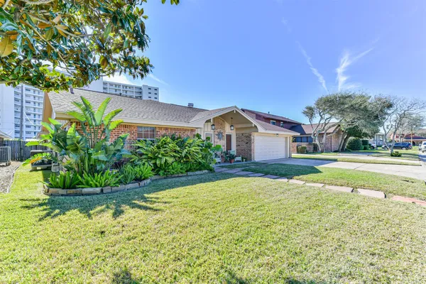 a view of house with swimming pool and yard