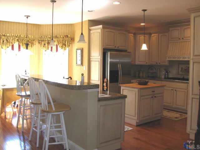3320 La Costa Way Raleigh, NC 27610 - Photo 3 of 10 a kitchen with kitchen island granite countertop a sink stainless steel appliances and cabinets