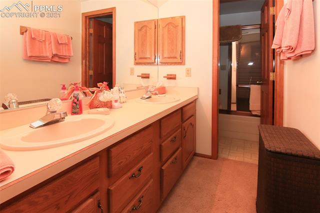 12020 Murphy Road Elbert, CO 80106 - Photo 27 of 39 Full bathroom in the basement has dual sink vanity.