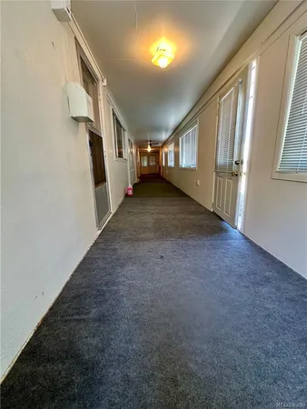 a view of a workspace with furniture and wooden floor